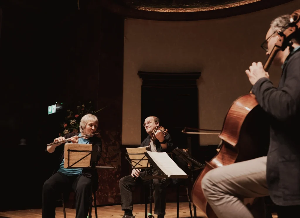 Benjamin Nabarro on violin, Philippa Davies on flute and Adrian Brendel on cello performing with The Nash Ensemble