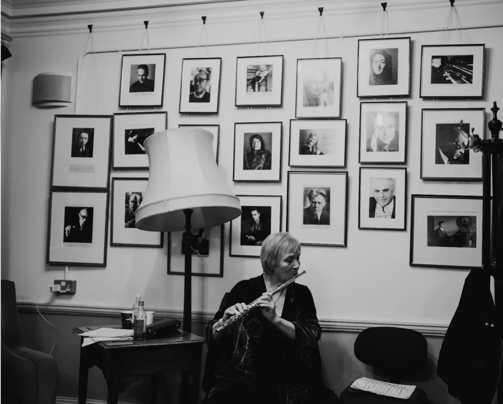 Philippa Davies back stage playing flute