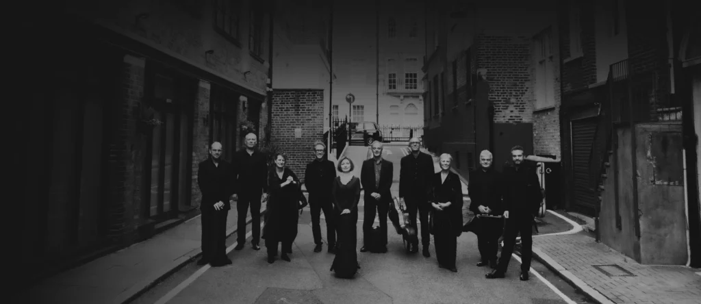 The Nash Ensemble outside in a lane posing together