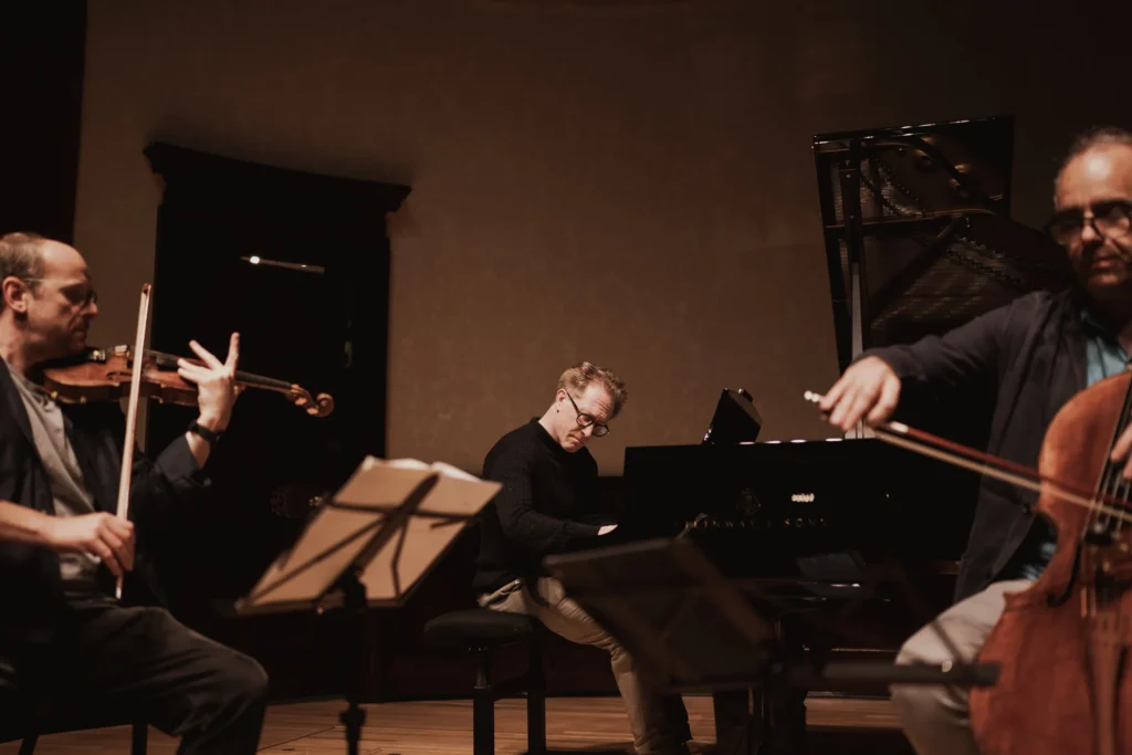 Benjamin Nabarro on violin, Simon Crawford-Philips on piano and Adrian Brendel on cello performing with The Nash Ensemble