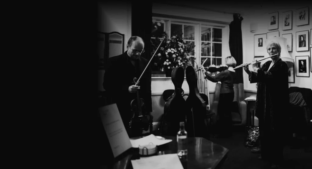 Benjamin Nabarro on violin, Philippa Davies on flute and Rachel Roberts on viola back stage with The Nash Ensemble